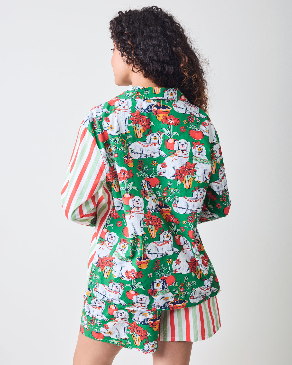 Back view of the Good Dog Christmas Reese boxer pajama set, showing the green dog-and-poinsettia print and striped sleeves and shorts.