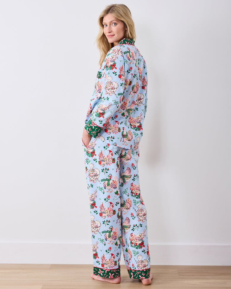 Back view of a person wearing the pale blue Holiday Hens long pajama set with matching printed top and full-length pants.