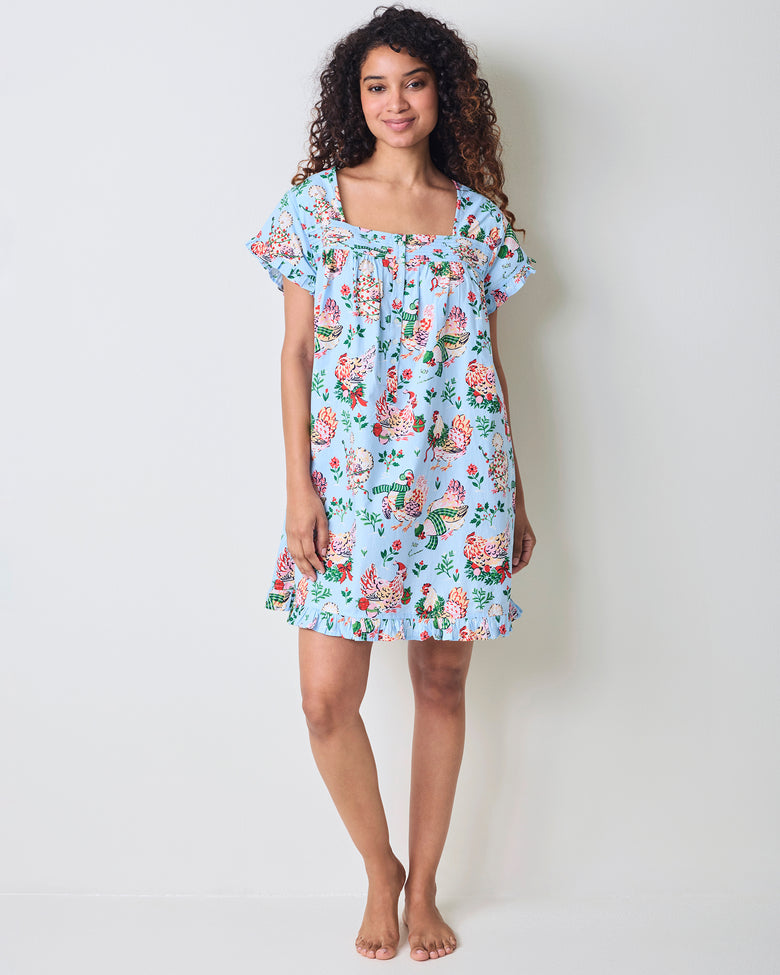 Front view of a pale blue Holiday Hens pintuck nightgown with short sleeves, button front, and ruffled hem.