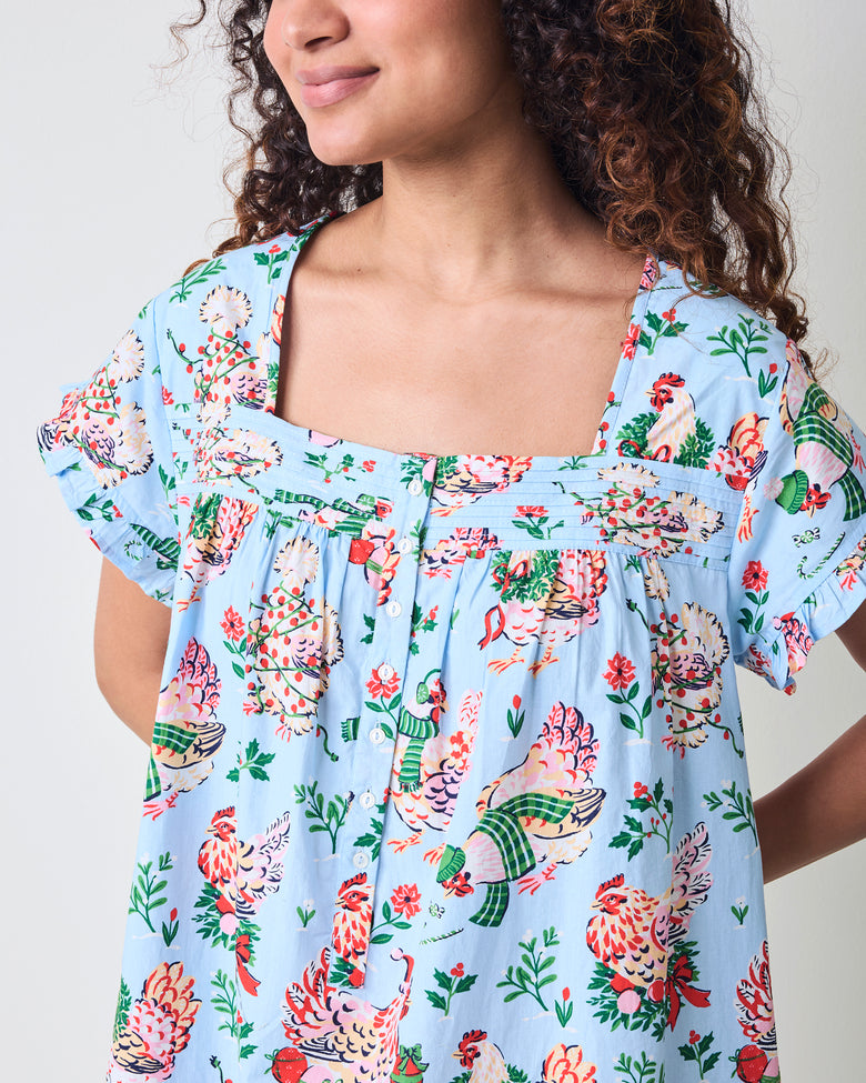 Close-up of the pale blue Holiday Hens nightgown neckline, pintuck detail, buttons, and printed fabric.