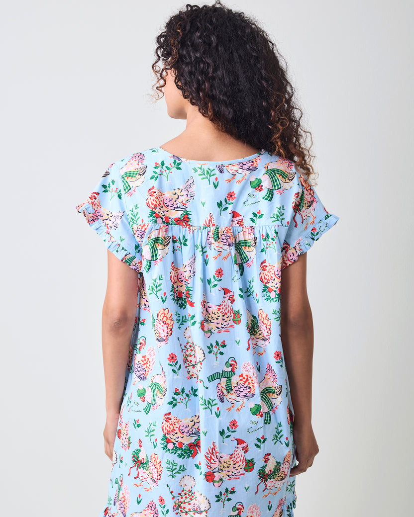 Back view of the pale blue Holiday Hens pintuck nightgown with short sleeves, a gathered back yoke, and a hen-and-holiday print.