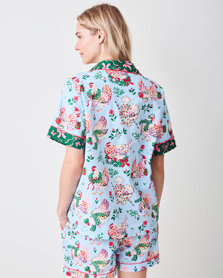 Back view of a person wearing the pale blue Holiday Hens short pajama set with printed top and shorts.