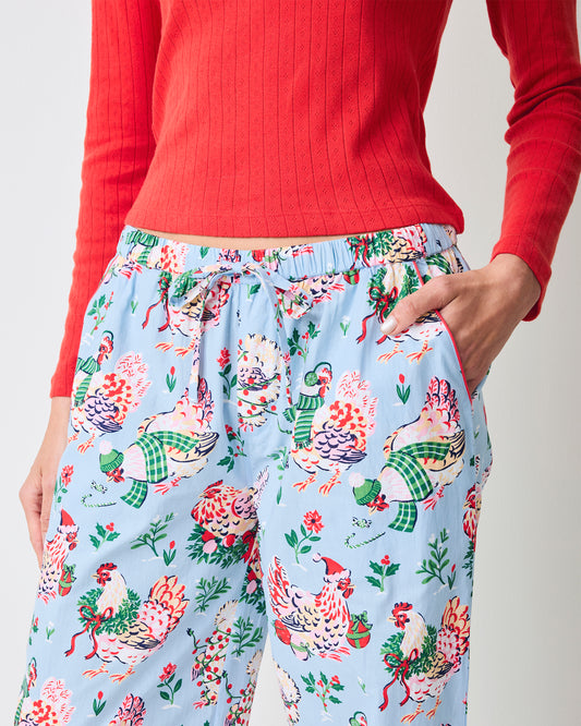 Close-up of the pale blue Holiday Hens pajama pants showing the drawstring waistband, side pockets, and printed hen design.