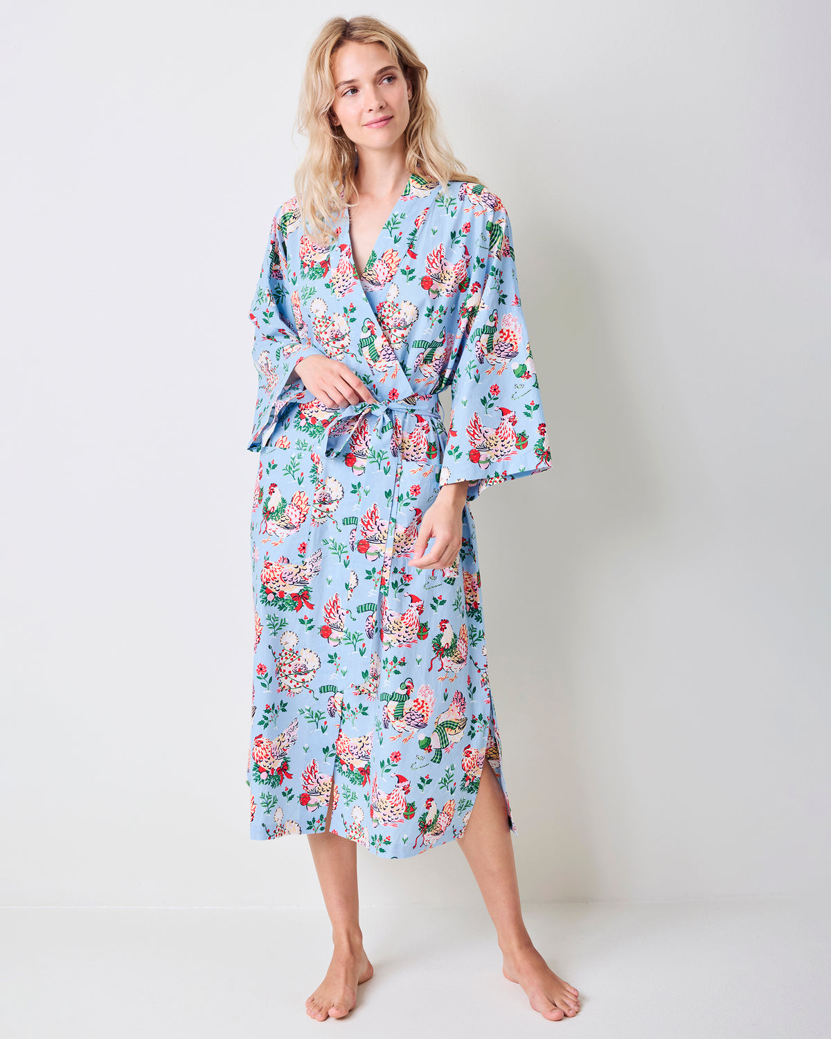 Full-length view of the pale blue Holiday Hens robe with a floral hen print, wrap front, belt, and three-quarter sleeves.