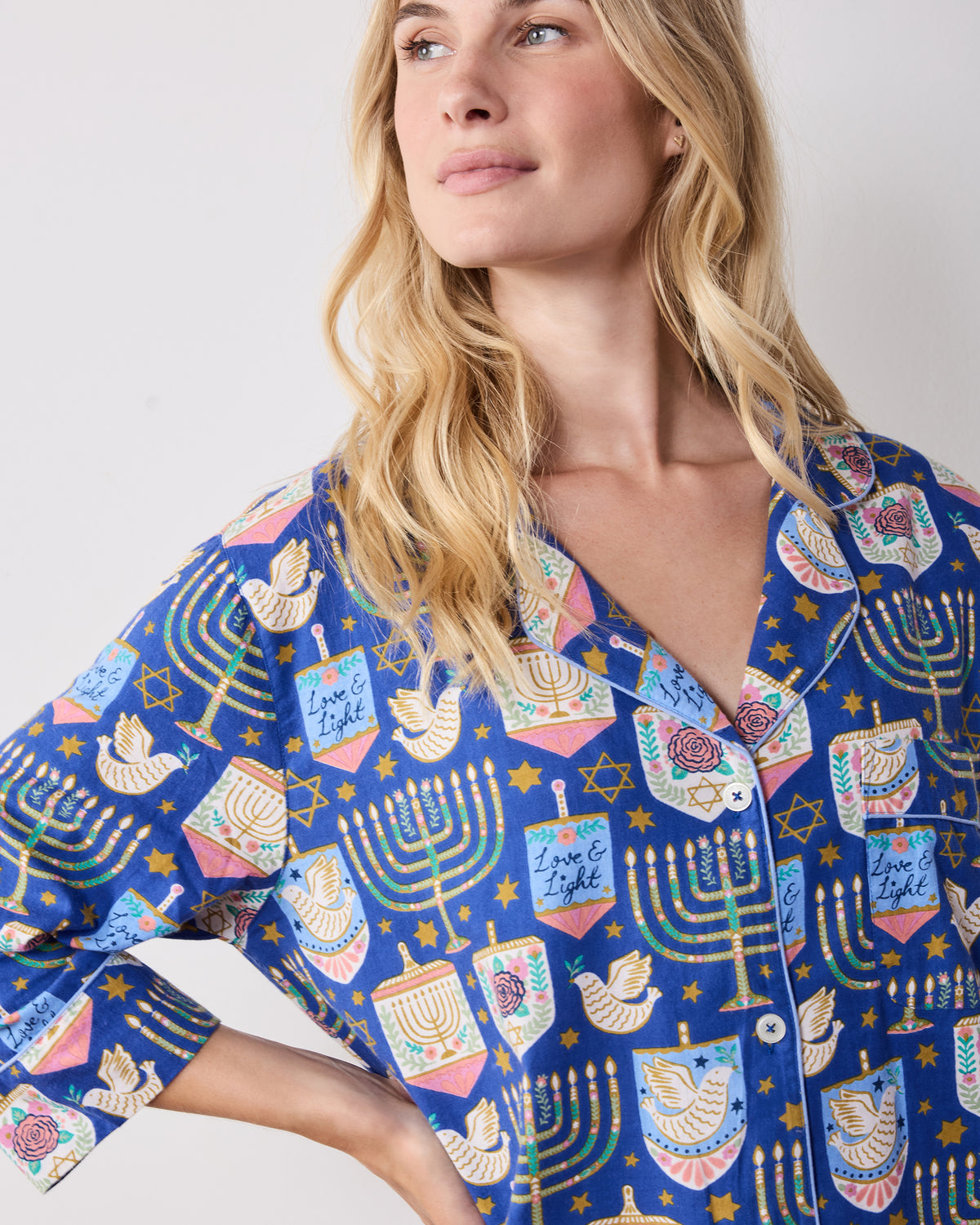 Close-up front view of the blue patterned sleep shirt showing the notched collar, white buttons, and long sleeve.