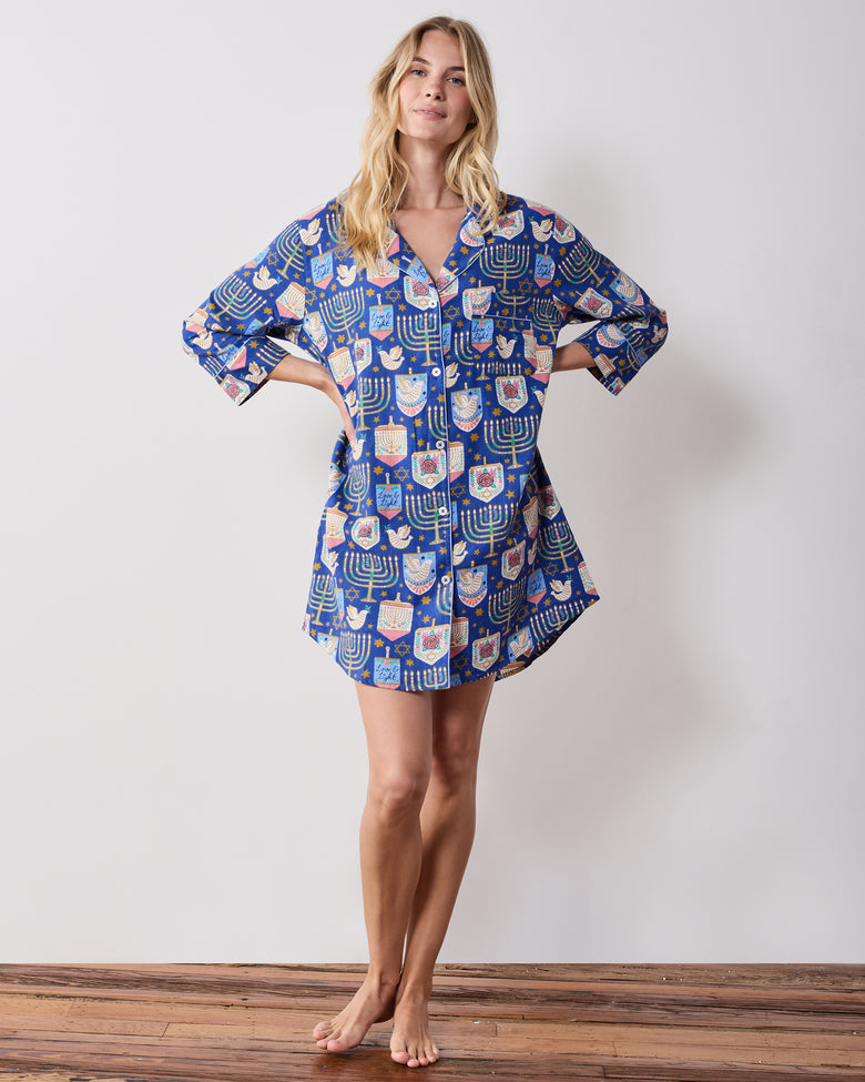 Front view of a blue patterned Love & Light sleep shirt with long sleeves, a collar, button front, and curved hem.