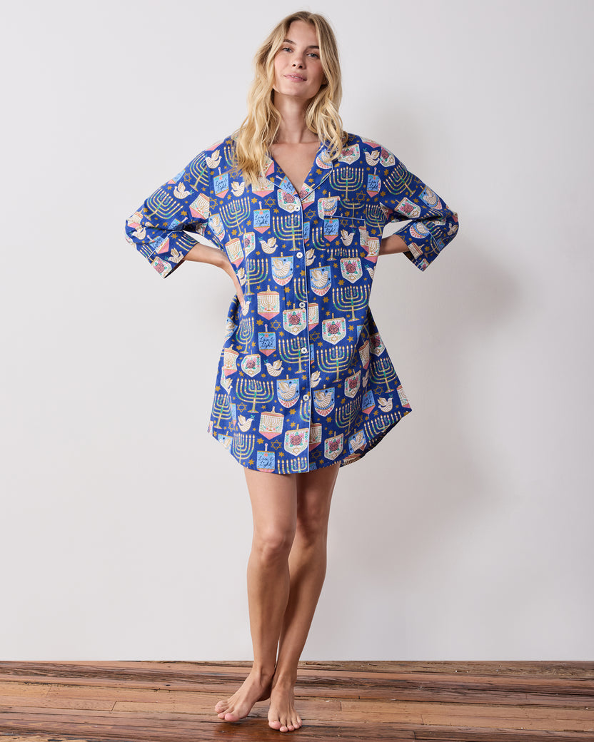 Front view of a blue patterned Love & Light sleep shirt with long sleeves, a collar, button front, and curved hem.