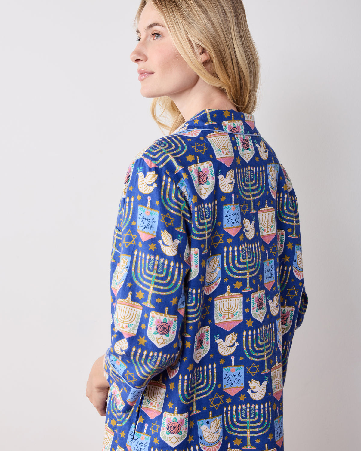 Side and back view of the blue patterned Love & Light sleep shirt, showing the collar, long sleeves, and curved hem.