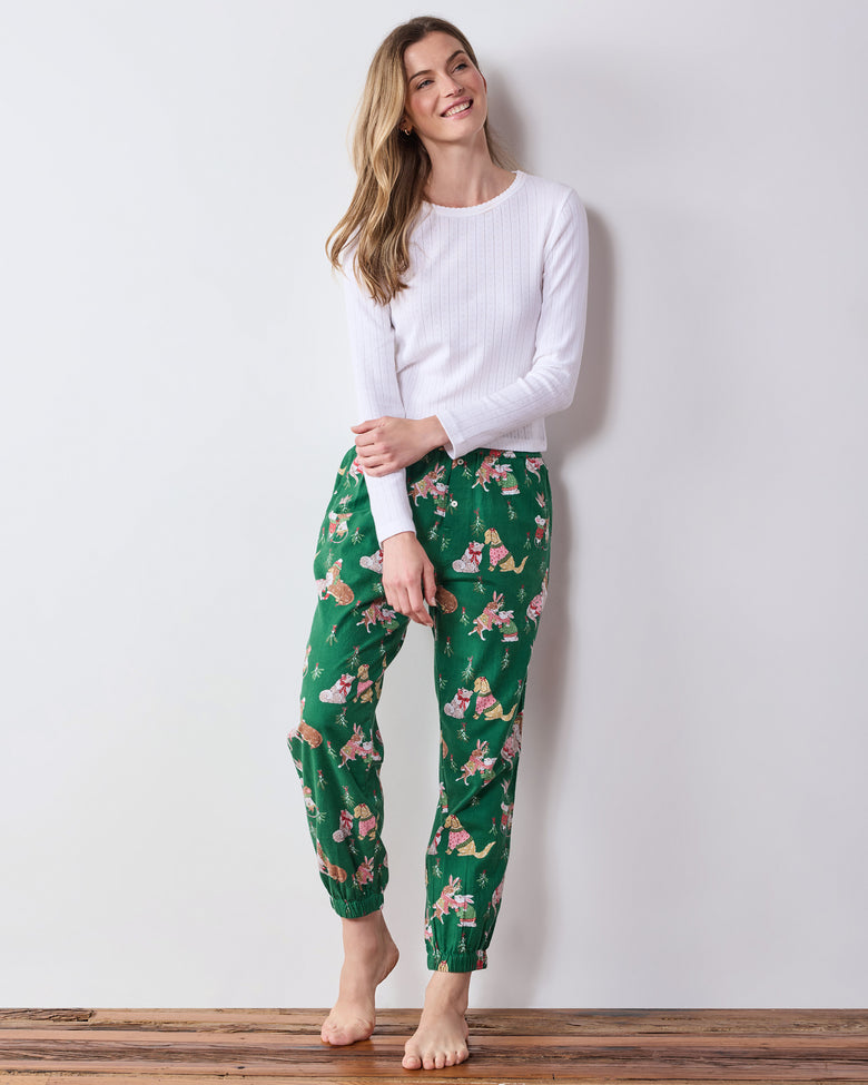 Full-length front view of a model wearing green printed joggers with gathered ankle cuffs.