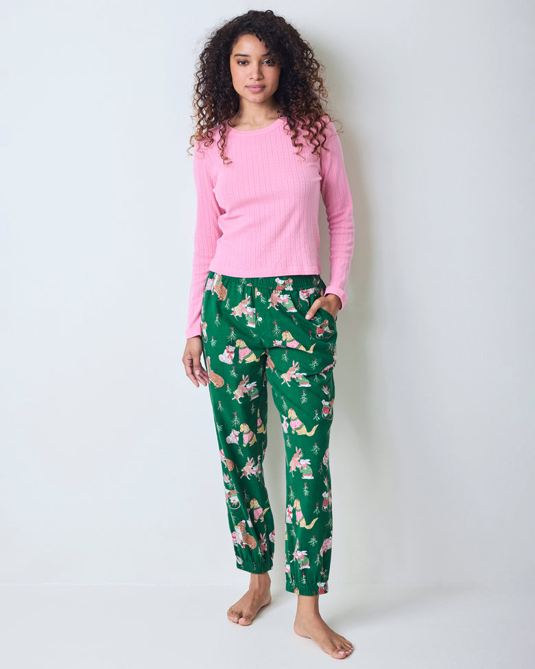 Full-length front view of a model wearing green printed joggers with a pink long-sleeve top and gathered ankle cuffs.