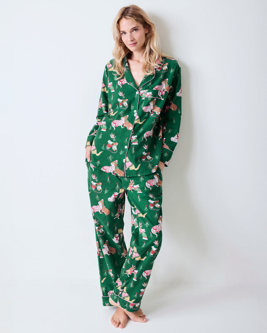Full front view of the green Mistletoe Kiss flannel pajama set with a collared button-down top, matching pants, pockets, and holiday critter print.