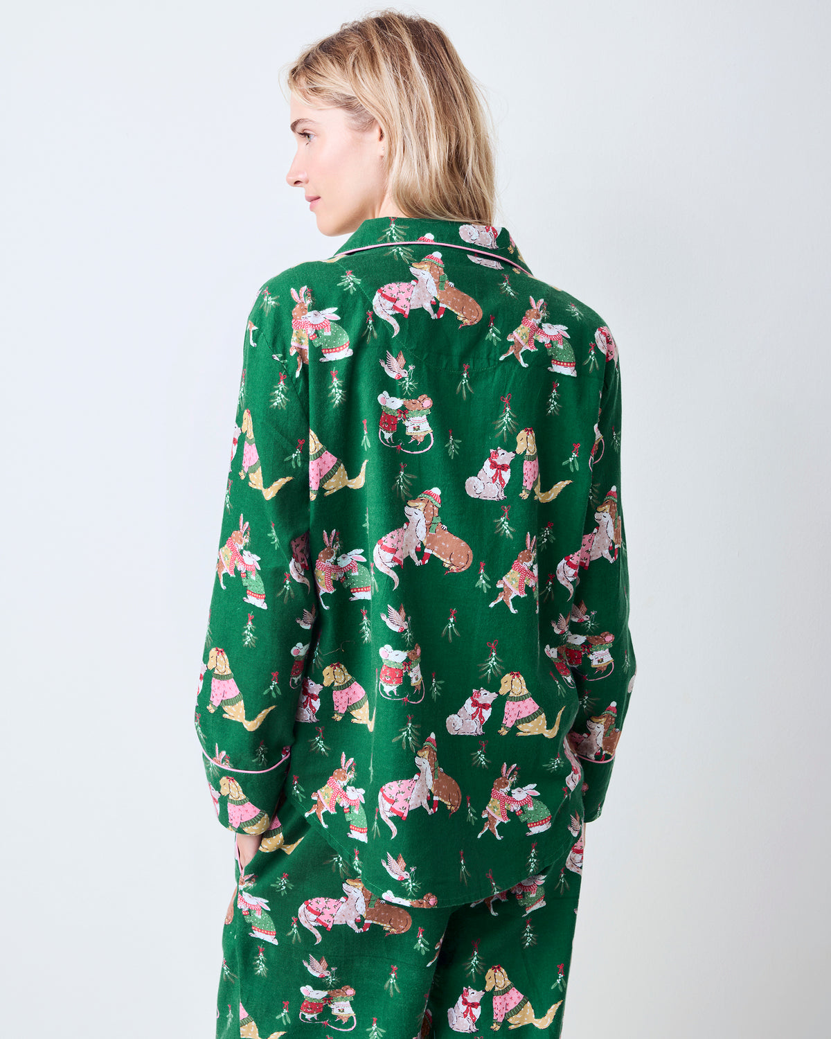 Back view of the green Mistletoe Kiss flannel pajama set with an all-over holiday critter print.