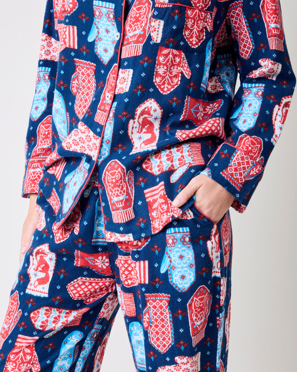 Close-up of the Viking Blue Nordic Mittens pajama set showing the top hem, side pocket, waistband, and matching mitten print.