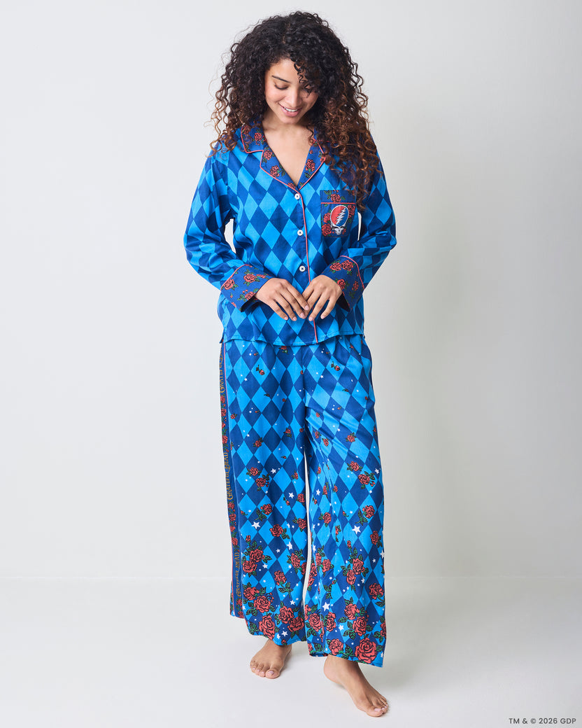 Full-length front view of the blue argyle Soho pajama set with rose-patterned trim, wide-leg pants, and a skull-and-lightning chest pocket.