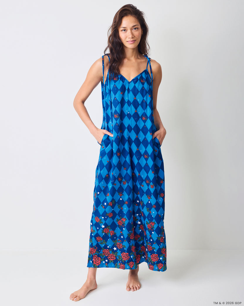 Front view of the blue argyle-print Jaipur jumpsuit with rose and star motifs, shown with side pockets.