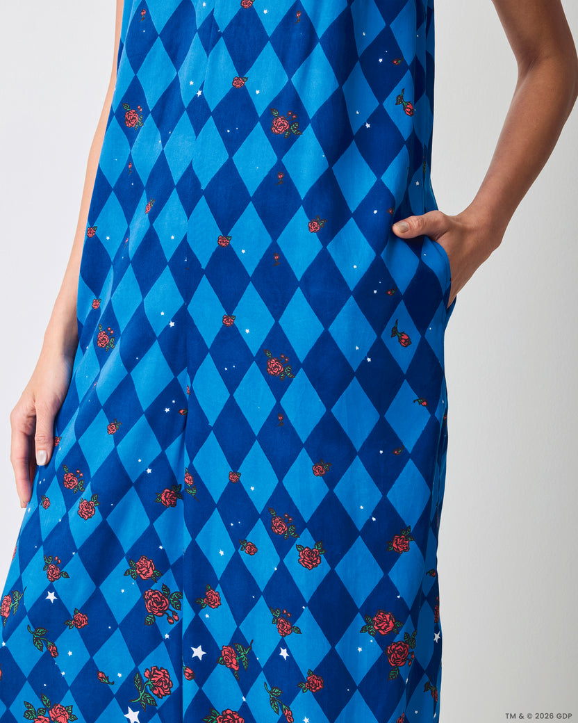 Close-up of the blue argyle-print Jaipur jumpsuit showing a hand in the side pocket and rose and star motifs.