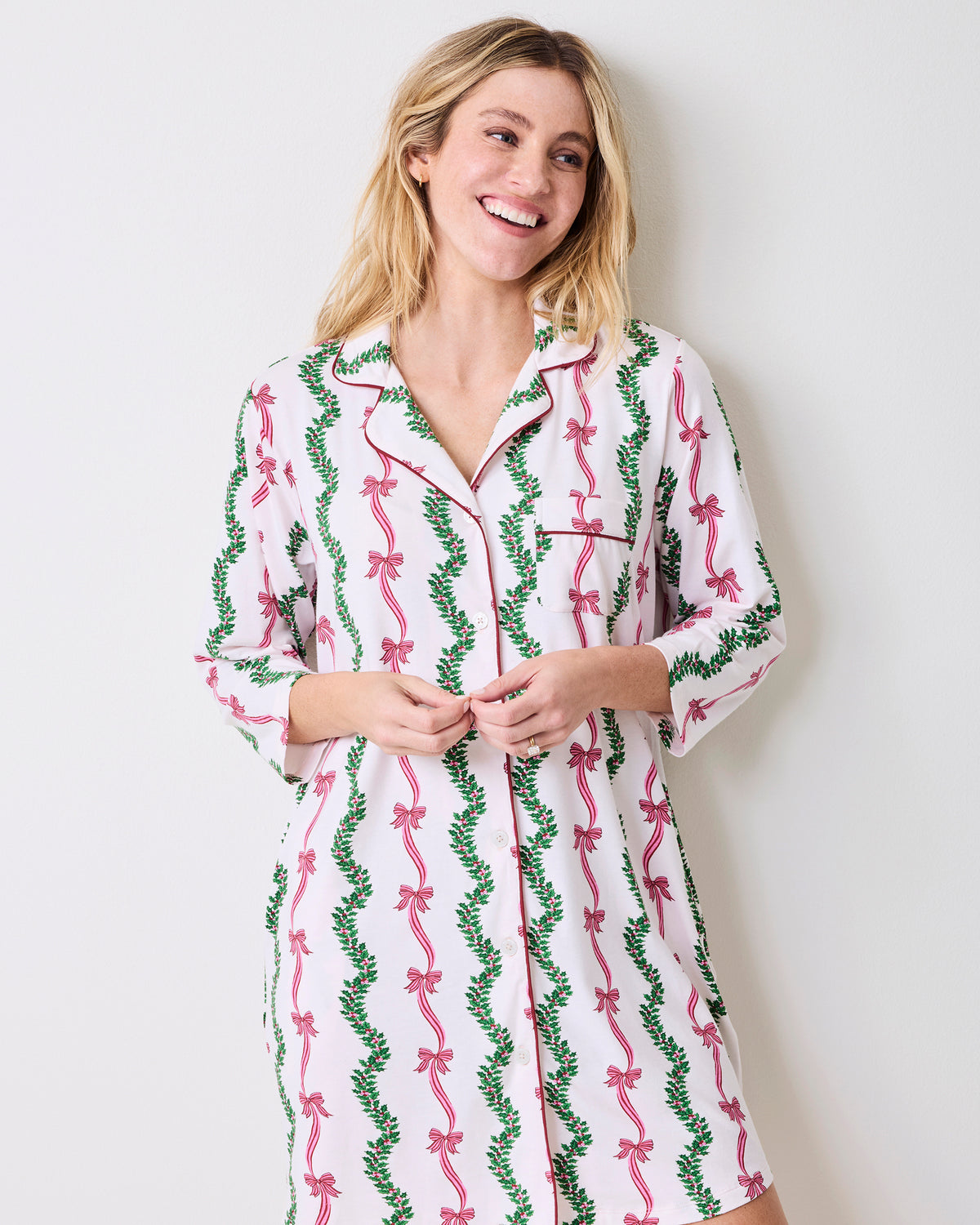 Model wearing the Ribbons & Bows sleep shirt, shown from a slight angle with its collar, button front, chest pocket, and three-quarter sleeves.