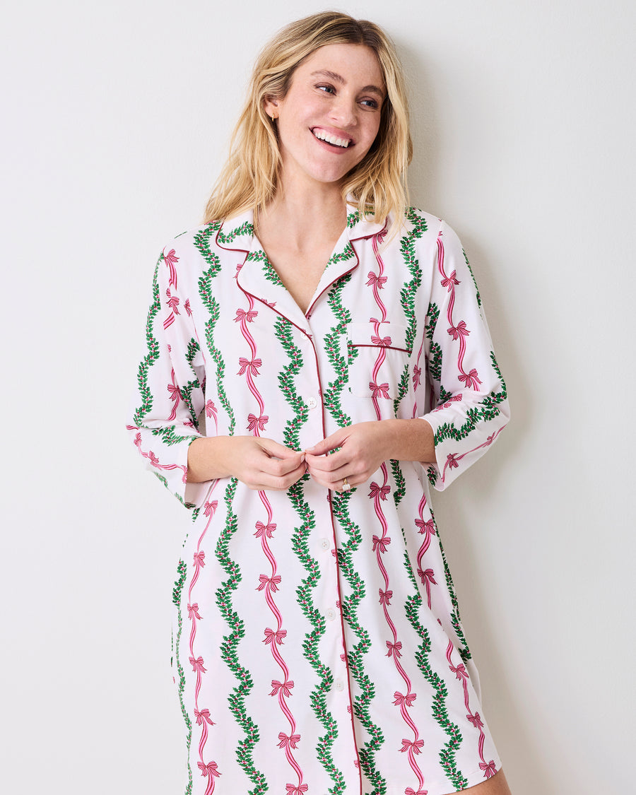 Model wearing the Ribbons & Bows sleep shirt, shown from a slight angle with its collar, button front, chest pocket, and three-quarter sleeves.