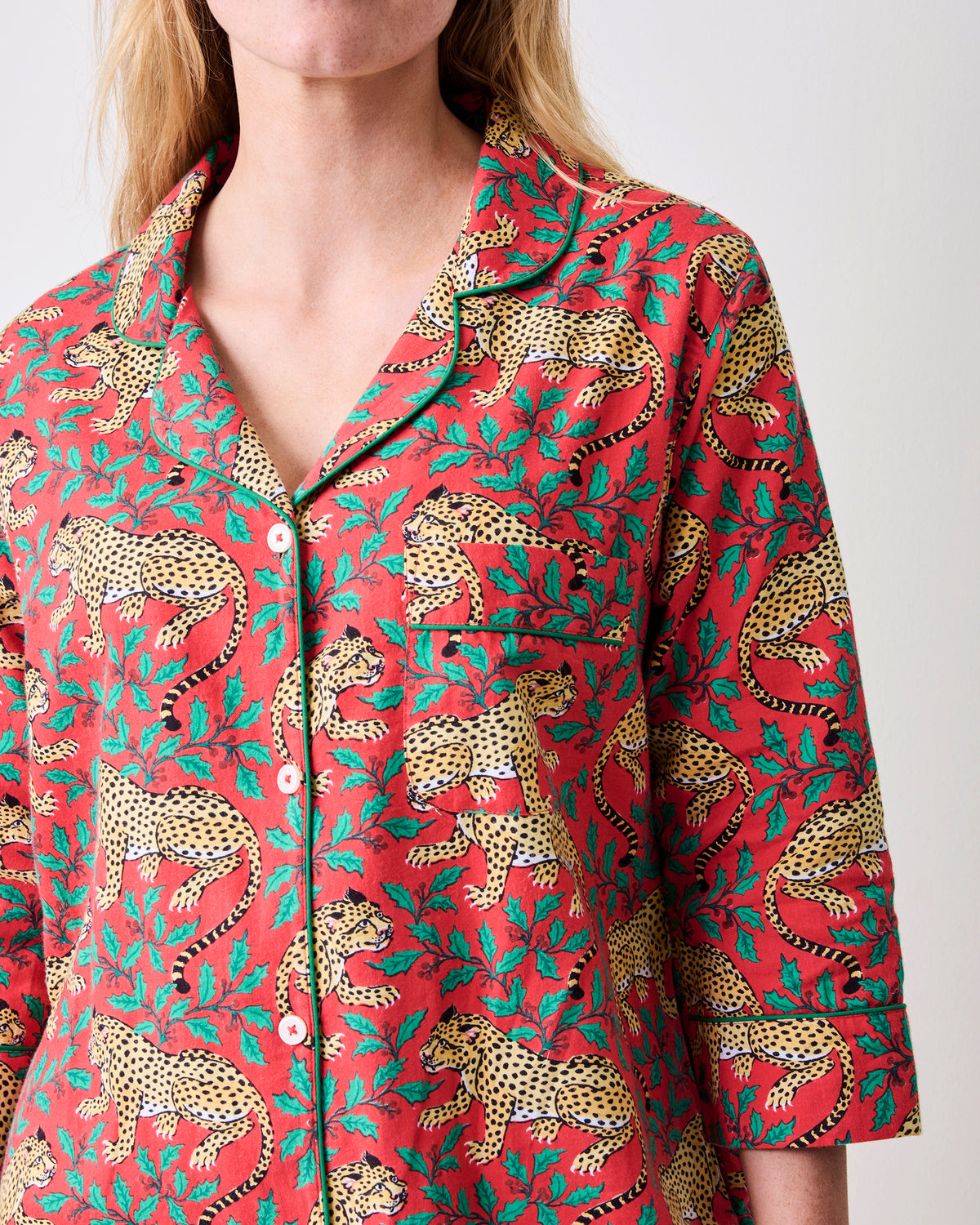 Close-up of the Ruby sleep shirt showing its collar, white buttons, chest pocket, three-quarter sleeve, and leopard-and-floral print