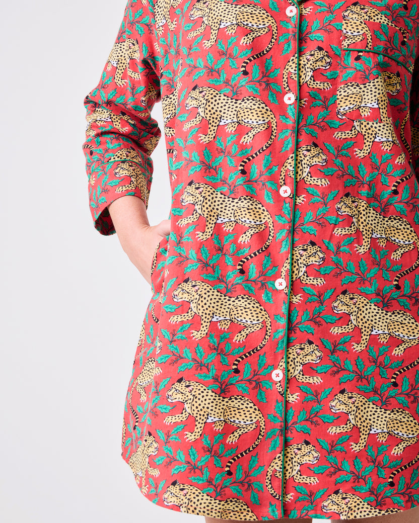 Close-up of the Ruby sleep shirt showing the button placket, side pocket, curved hem, and leopard-and-floral print