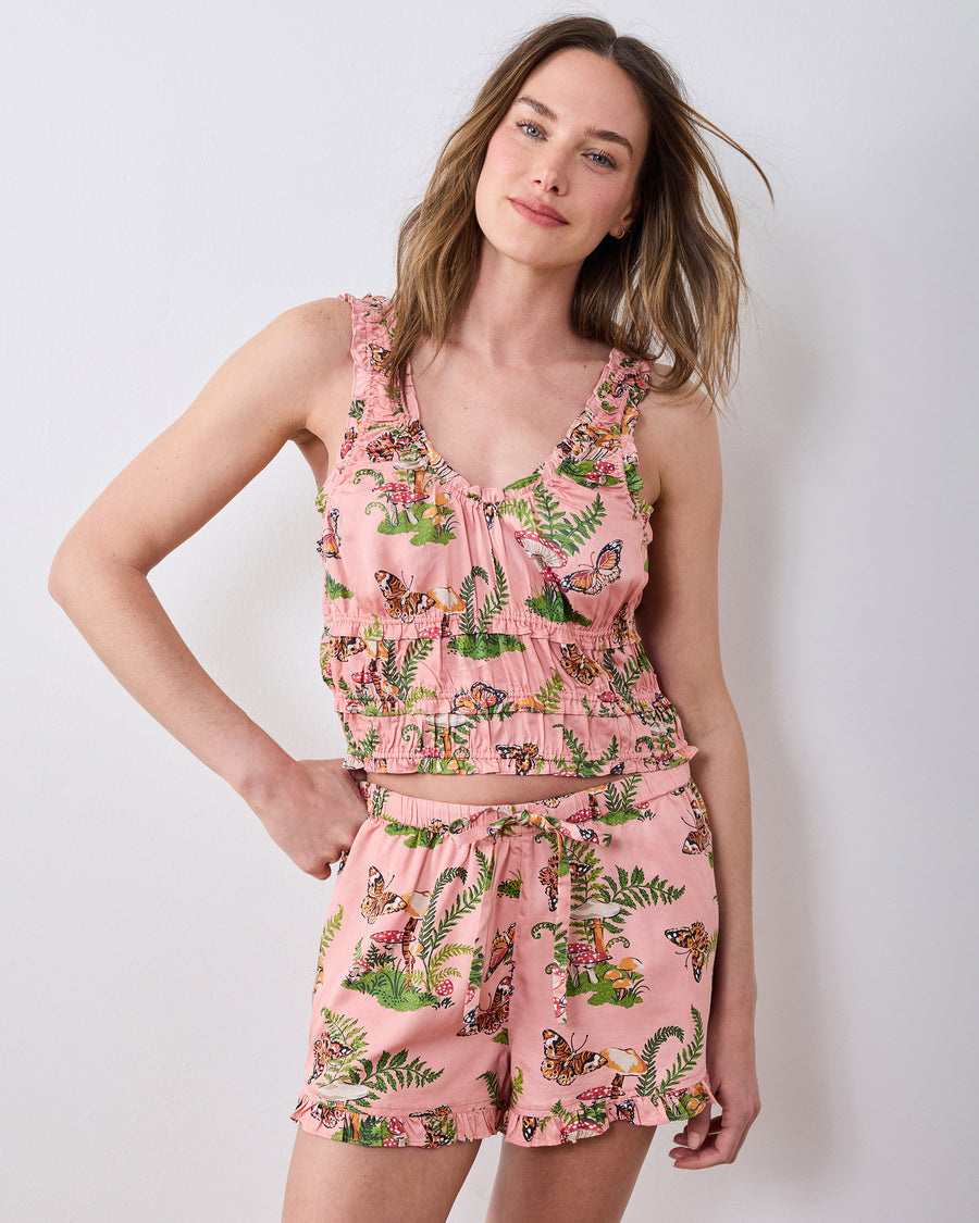 Front view of the rosewood Butterfly Forager short pajama set with a ruffle-trimmed tank and matching shorts printed with butterflies, mushrooms, and ferns.
