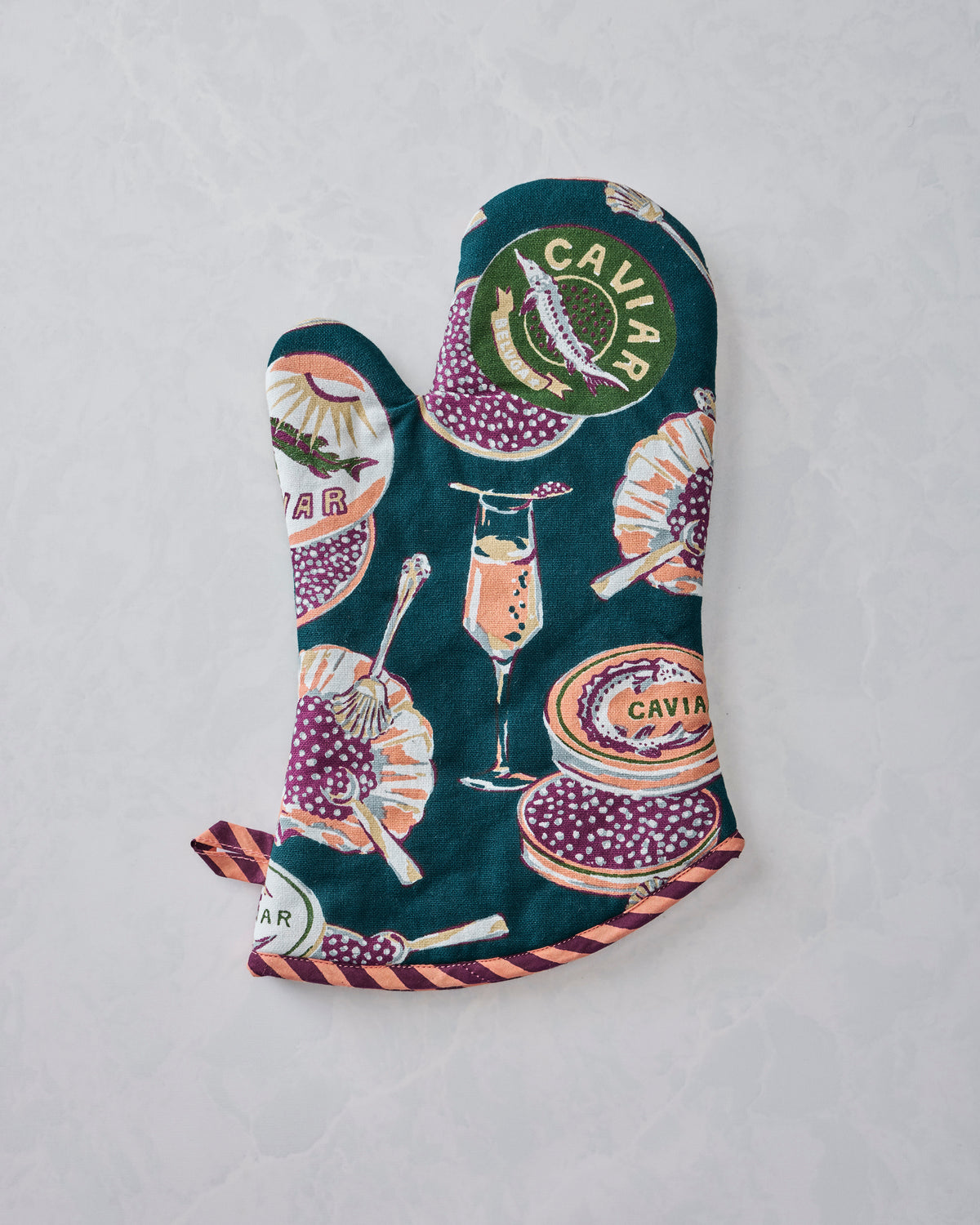 Peacock-feather oven mitt with a Champagne & Caviar print, shown from the reverse side.