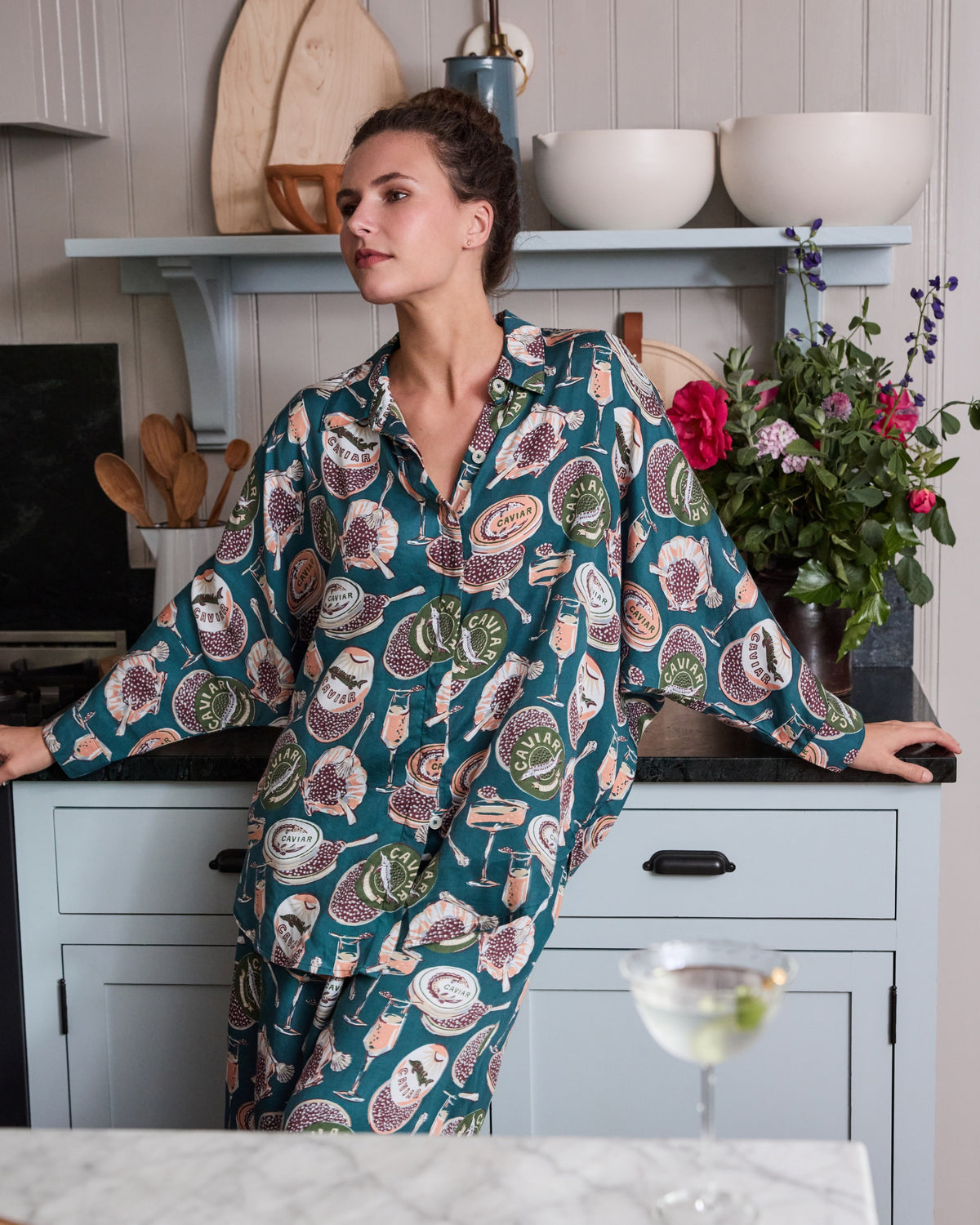 Front view of the Champagne & Caviar Petite Eco Satin Stevie pajama set in Peacock Feather print, showing the relaxed button-front top and matching wide-leg pants.