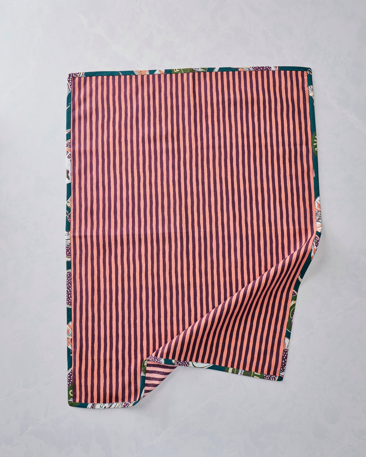 Reverse side of a Champagne & Caviar tea towel showing pink-and-brown vertical stripes.