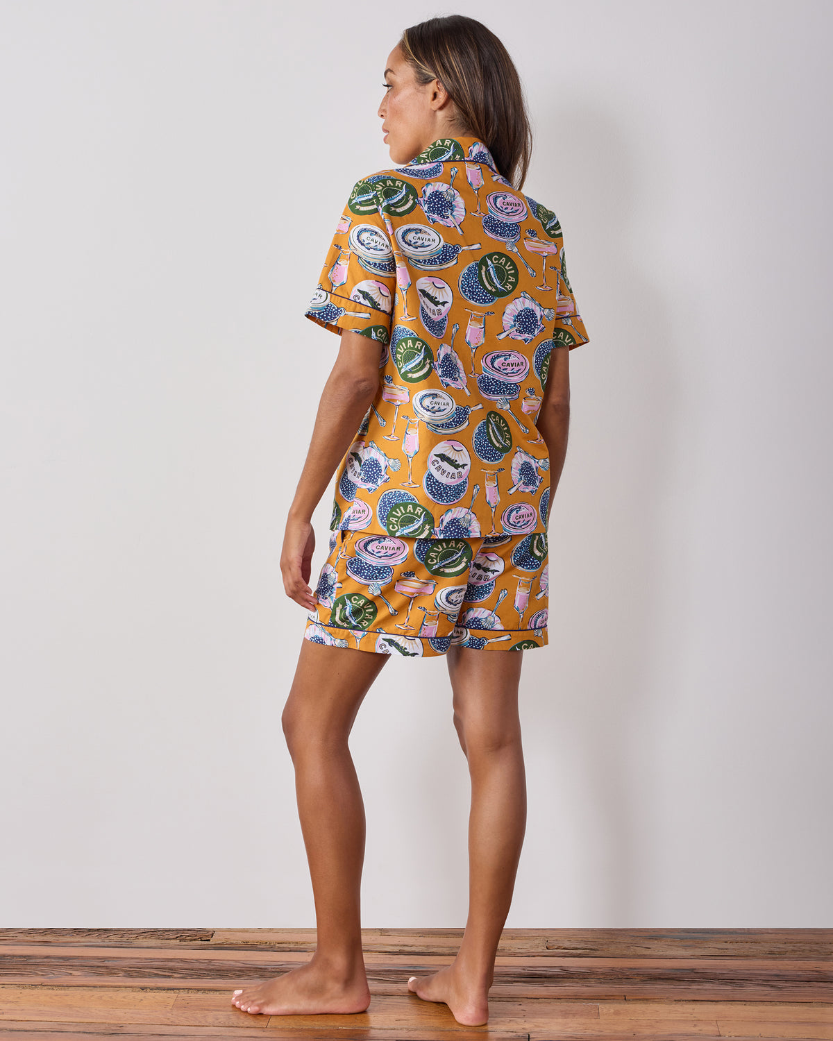 Back view of the goldenrod Champagne and Caviar short pajama set, showing the printed button-front top and matching shorts.