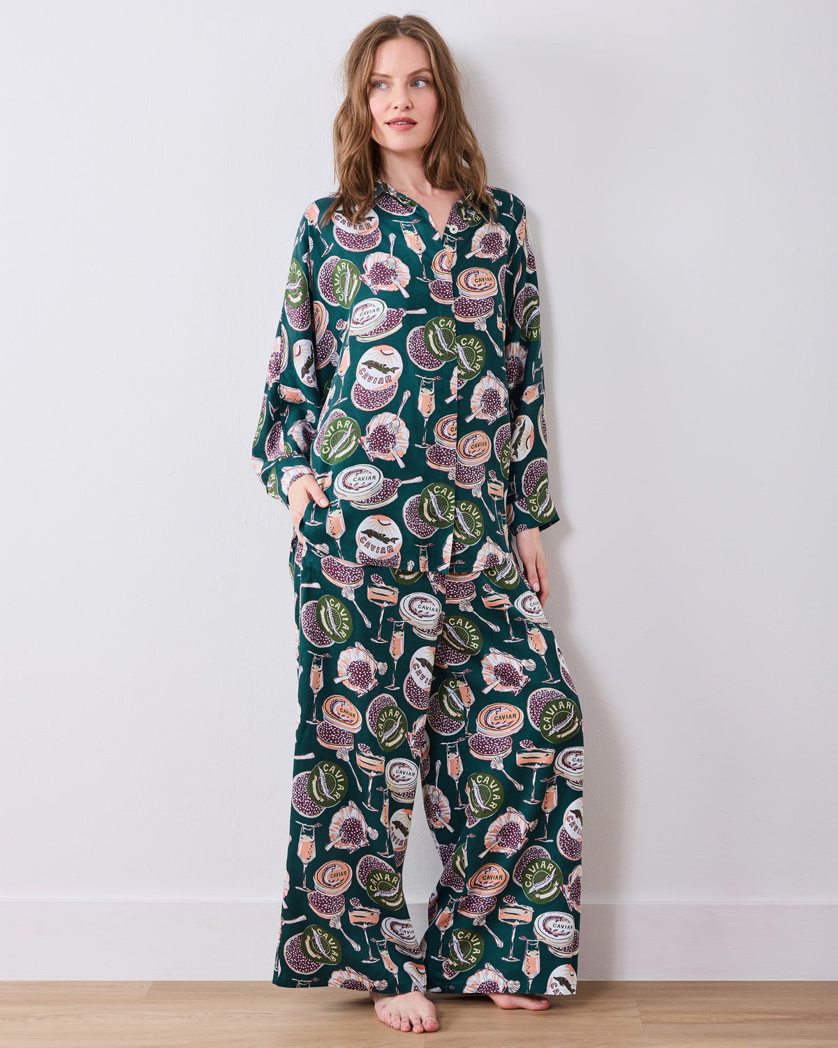 Full-length front view of the peacock-feather Champagne & Caviar Stevie pajama set with a button-front top and wide-leg pants.