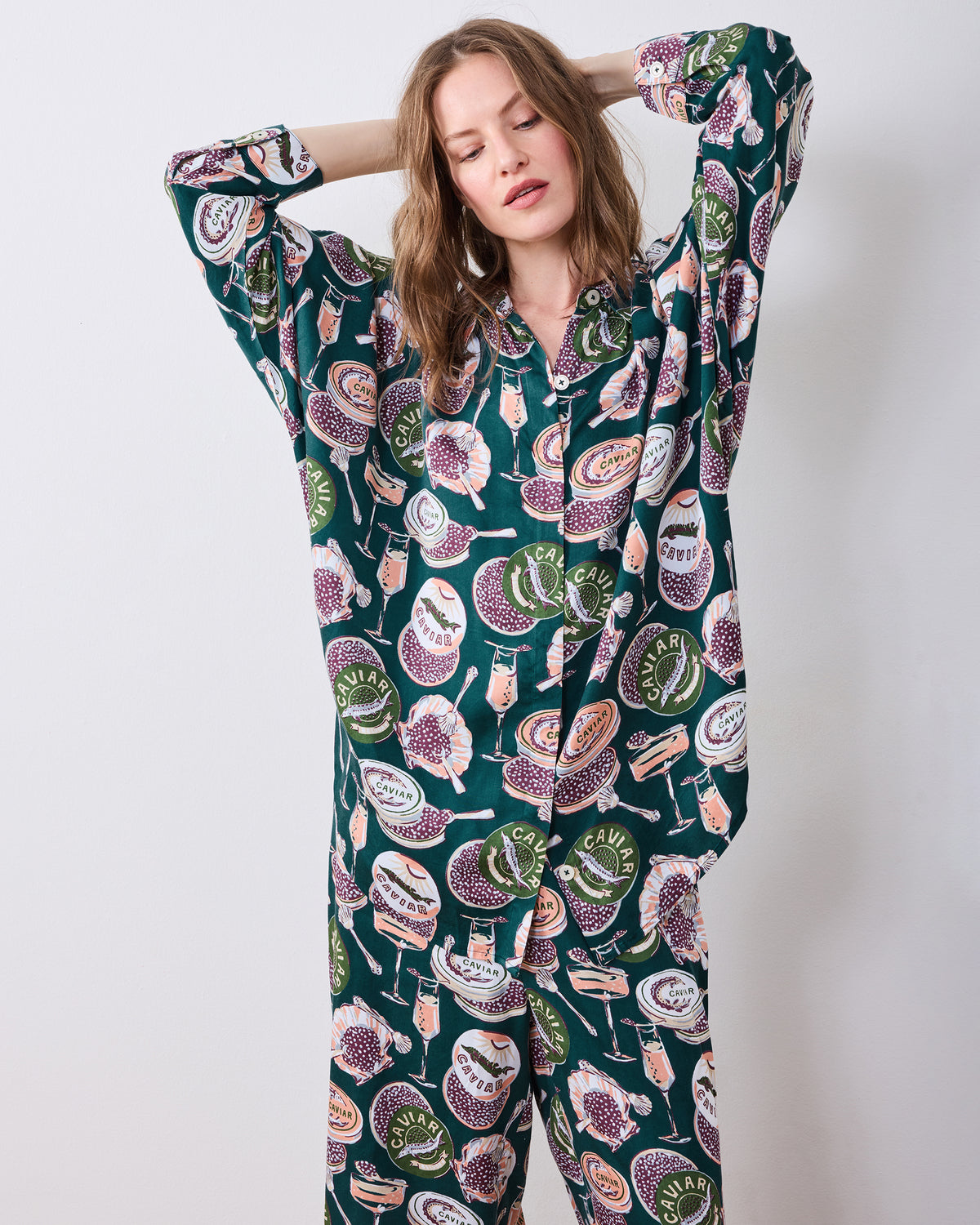 Front detail of the Champagne & Caviar Stevie pajama set showing the button-front top, cuffed sleeves, and printed wide-leg pants.