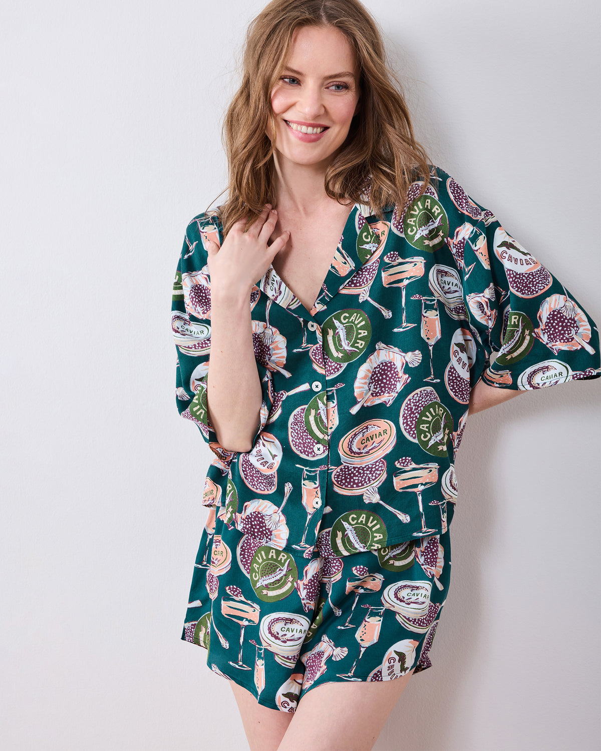 Closer front view of a short printed pajama set with a button-front shirt and matching shorts.