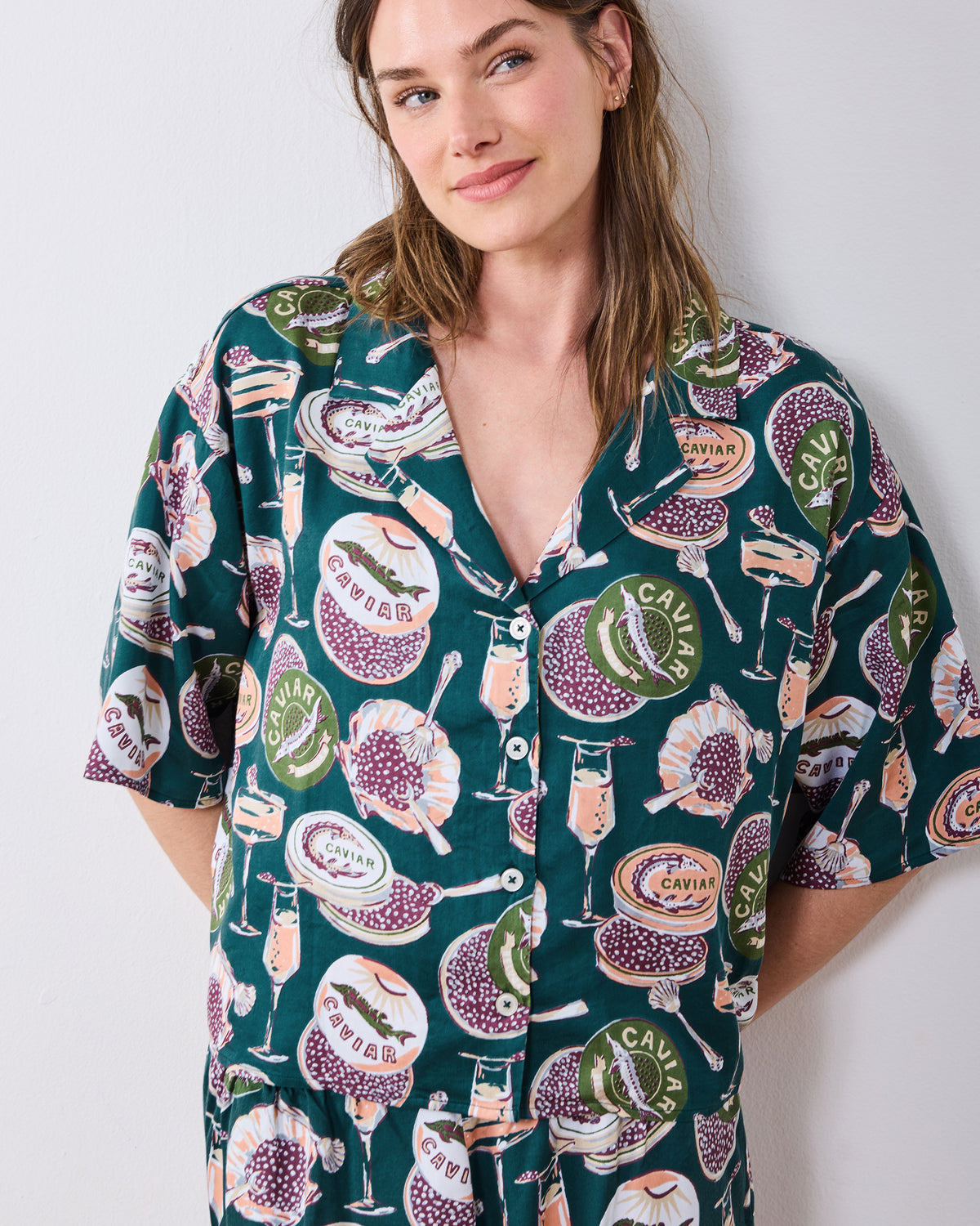 Front view of the petite Champagne & Caviar Wildest Dreams pajama top with short sleeves, buttons, and a printed pattern.