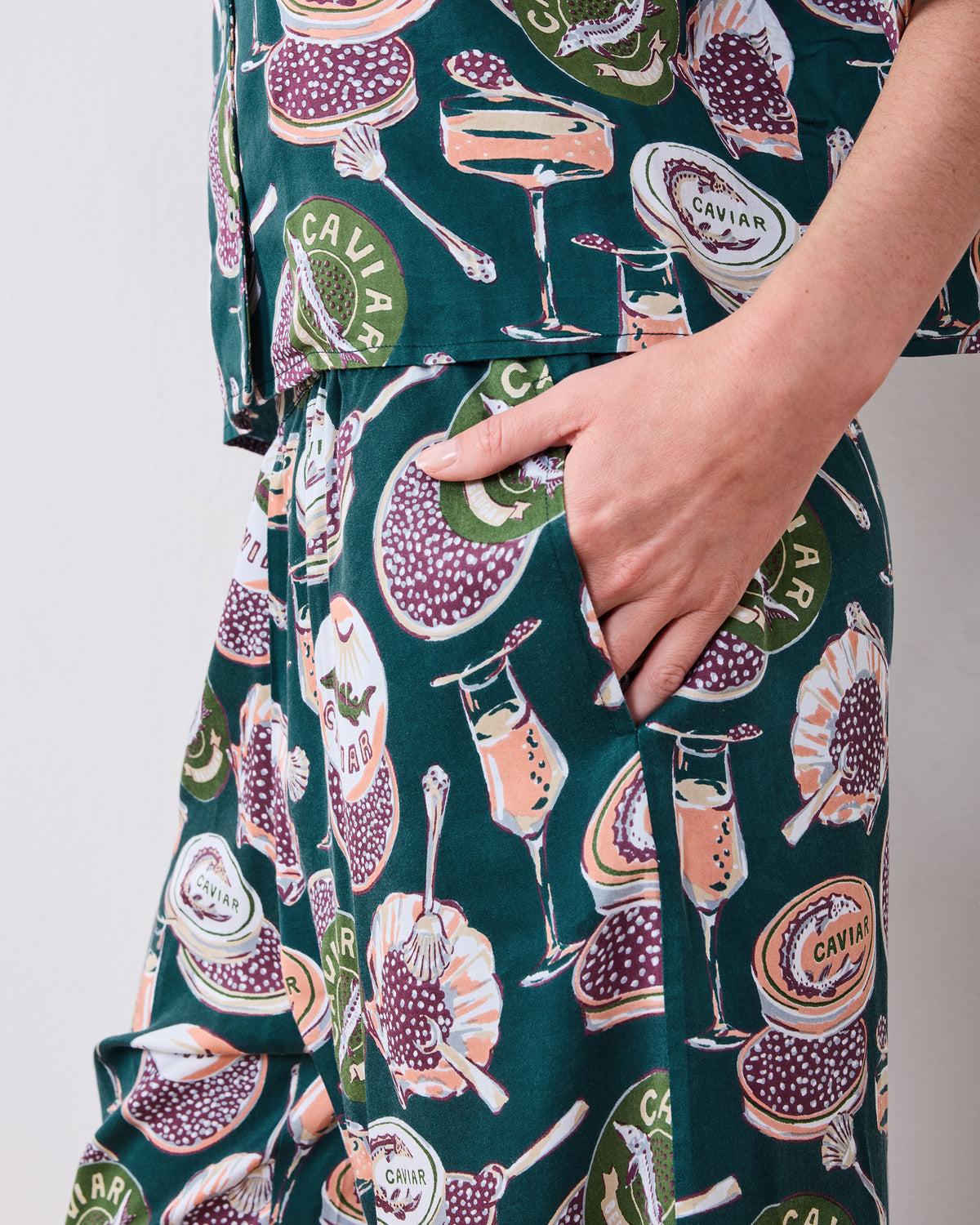 Close-up of the Champagne & Caviar Wildest Dreams pajama pants showing a side pocket and the printed pattern.