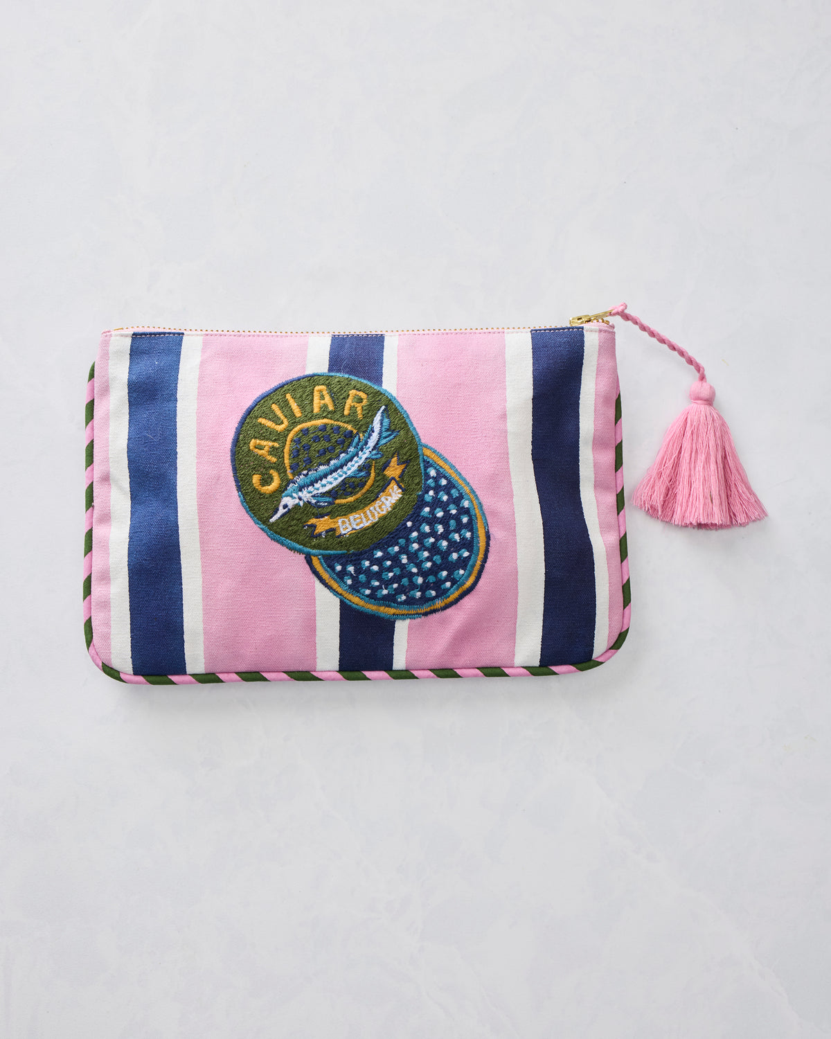Harbor Rose canvas pouch shown front-facing with pink and navy vertical stripes, a CAVIAR embroidered patch, zipper closure, and pink tassel.