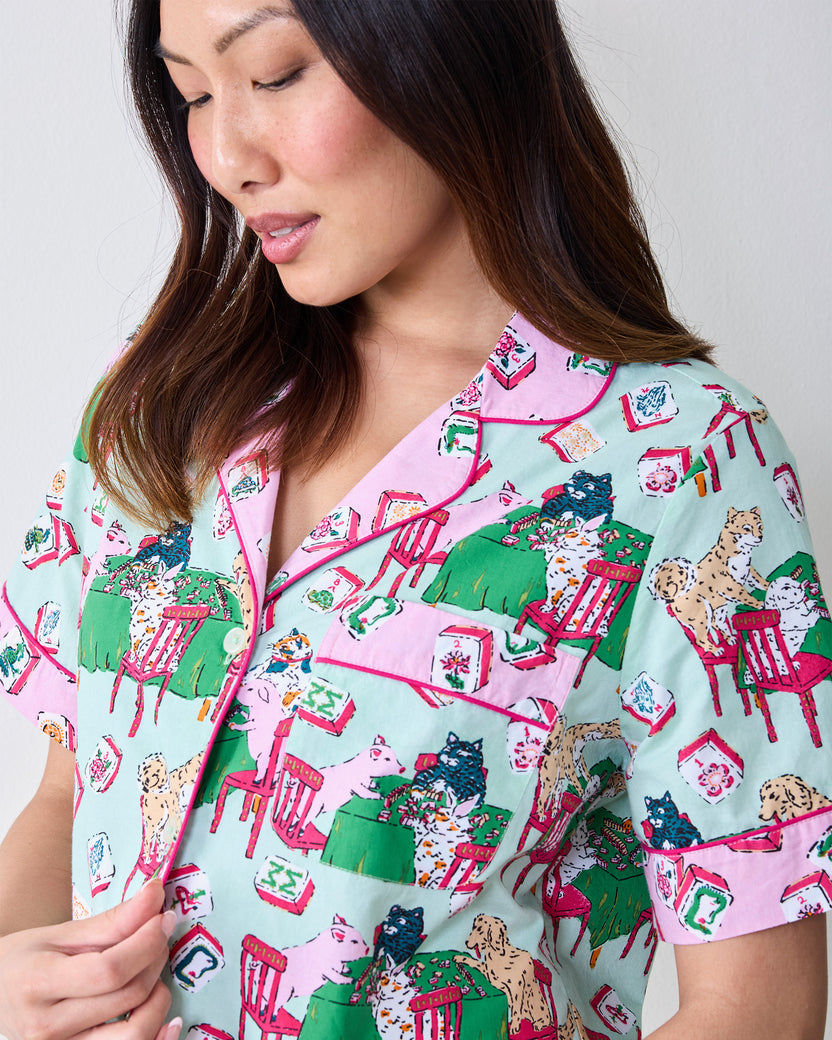 Close-up of the pale jade Mah Jongg Menagerie pajama shirt showing its collar, buttons, pocket, and colorful animal-and-tile print.