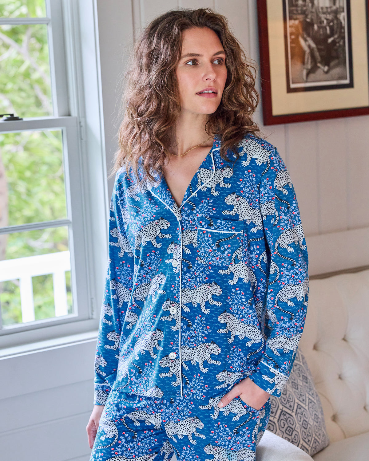 Model wearing the indigo Bagheera long pajama set beside a window