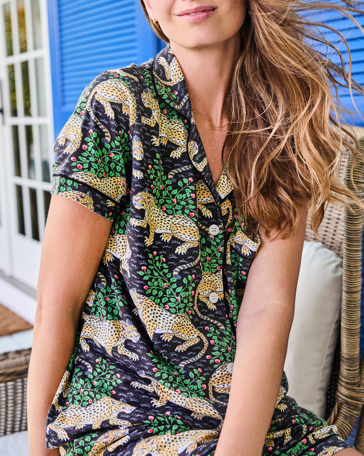 Close view of a black short-sleeve button-front pajama top with a leopard-and-floral print.