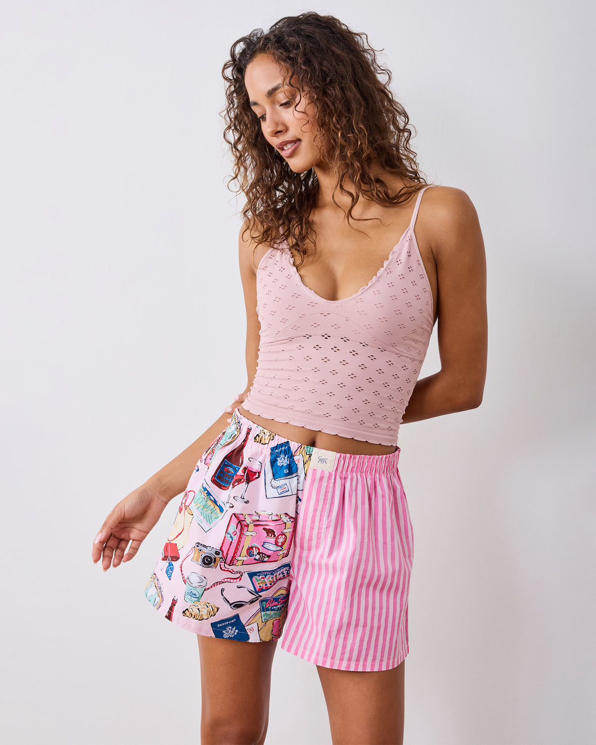 Front view of the Happy Place Pink boyfriend boxer shorts with an illustrated travel-themed print, worn with a pink camisole.