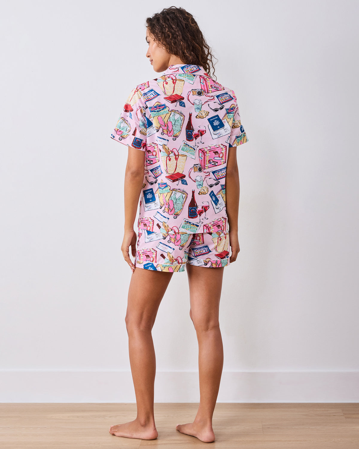 Back view of the Happy Place Pink short pajama set, showing the printed short-sleeve button-down top and matching shorts on a model.