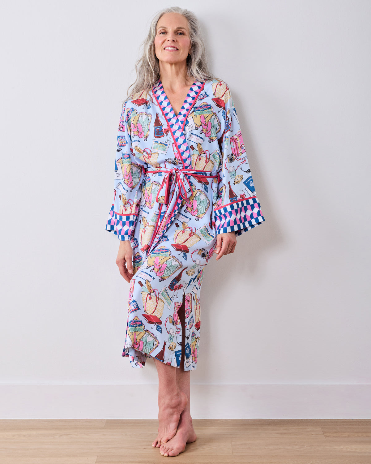 Front view of a person wearing a full-length pale blue printed robe with a matching belt and contrasting patterned cuffs.