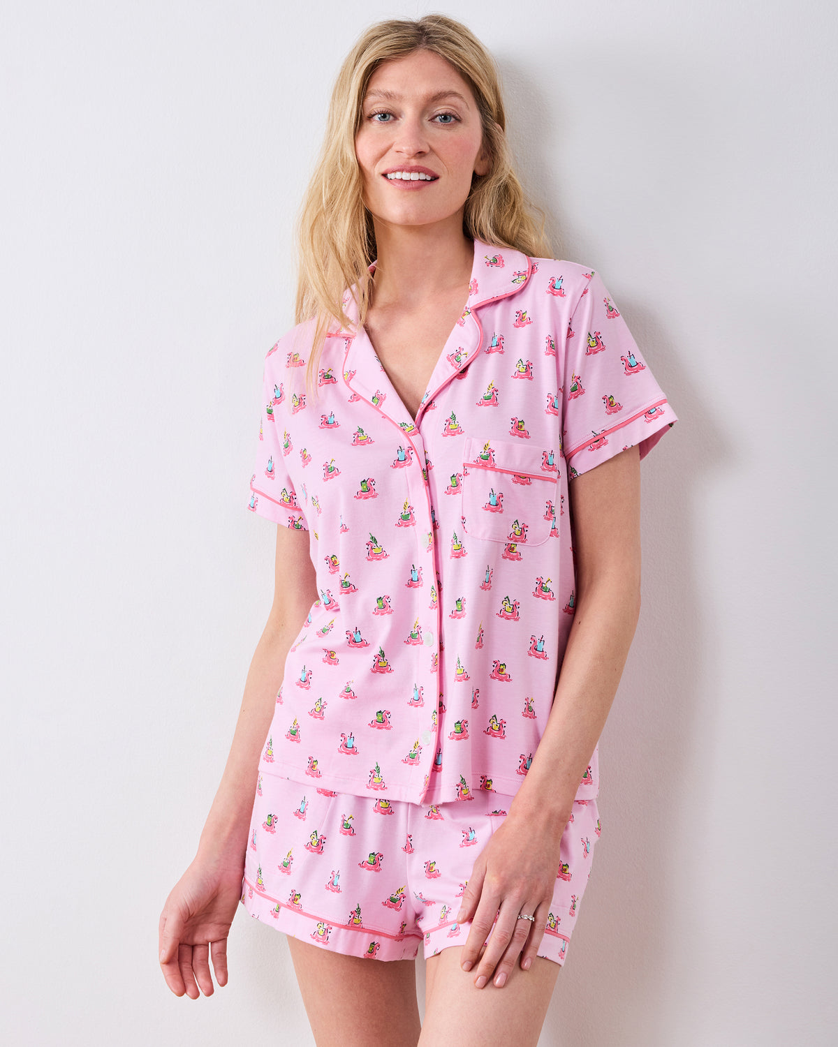 Front studio view of the pink flamingo-print button-down pajama top and matching shorts
