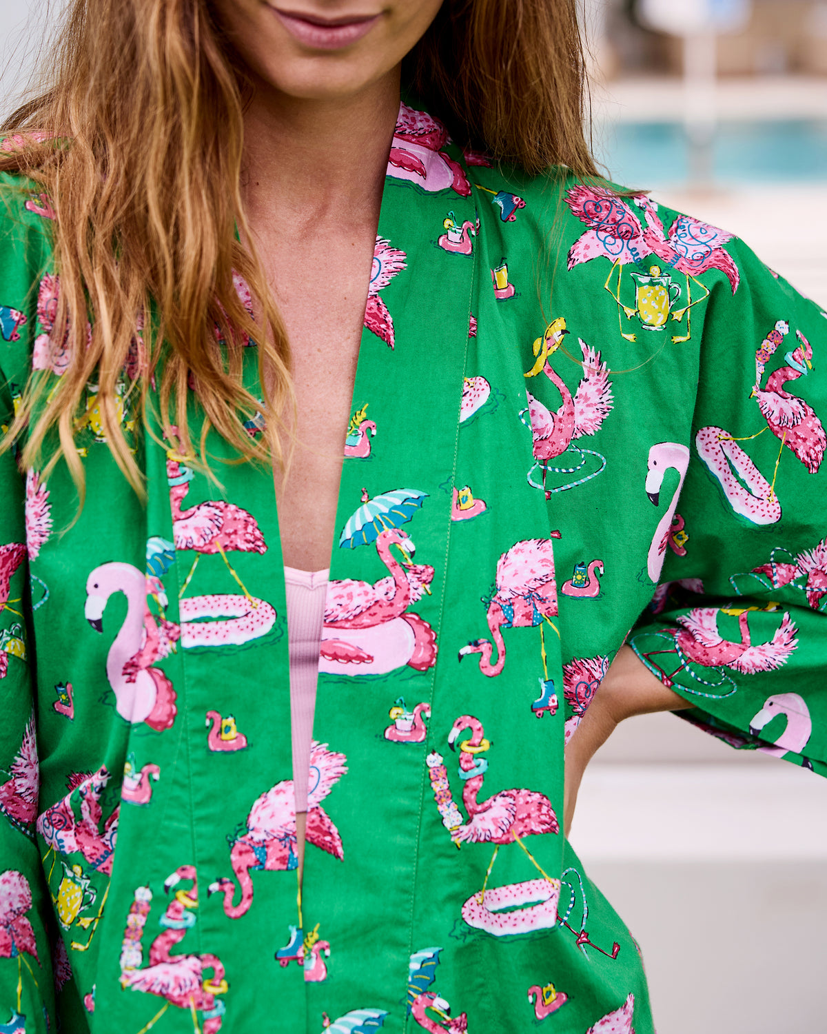 Close view of the open green robe and its pink flamingo print