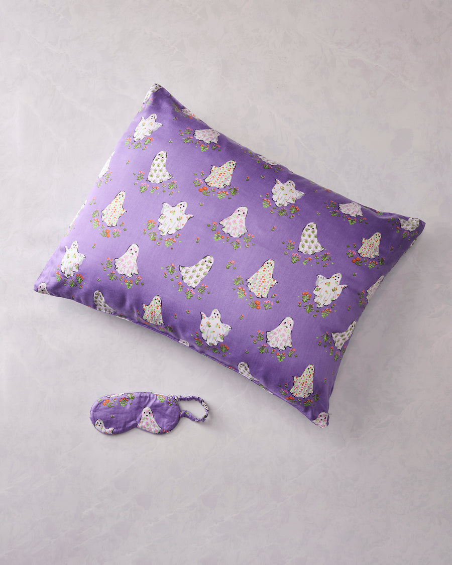 Eerie Amethyst Gardening Ghosts pillowcase and matching eye mask displayed on a light background.