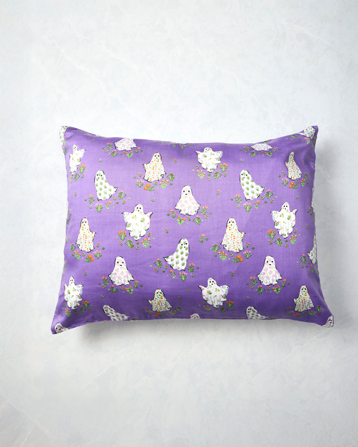 Eerie Amethyst pillowcase displayed flat with a purple background and a repeating print of white ghosts surrounded by small flowers.