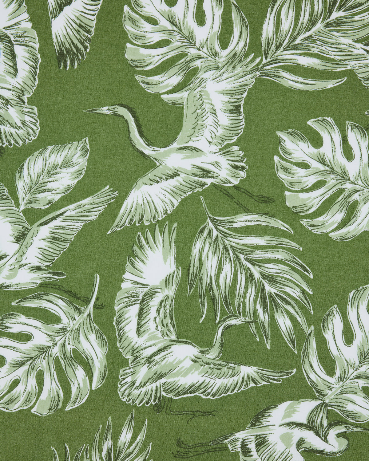 Close-up of the Heron Landing print with white herons and tropical leaves on an olive-green background