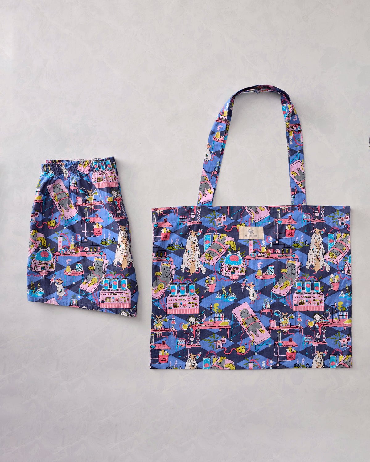 Checkered Sapphire It's Alive bundle showing patterned boyfriend boxers beside a matching tote bag.