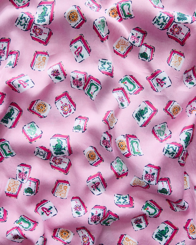 Peony pink fabric swatch with scattered colorful Mahjong tiles.