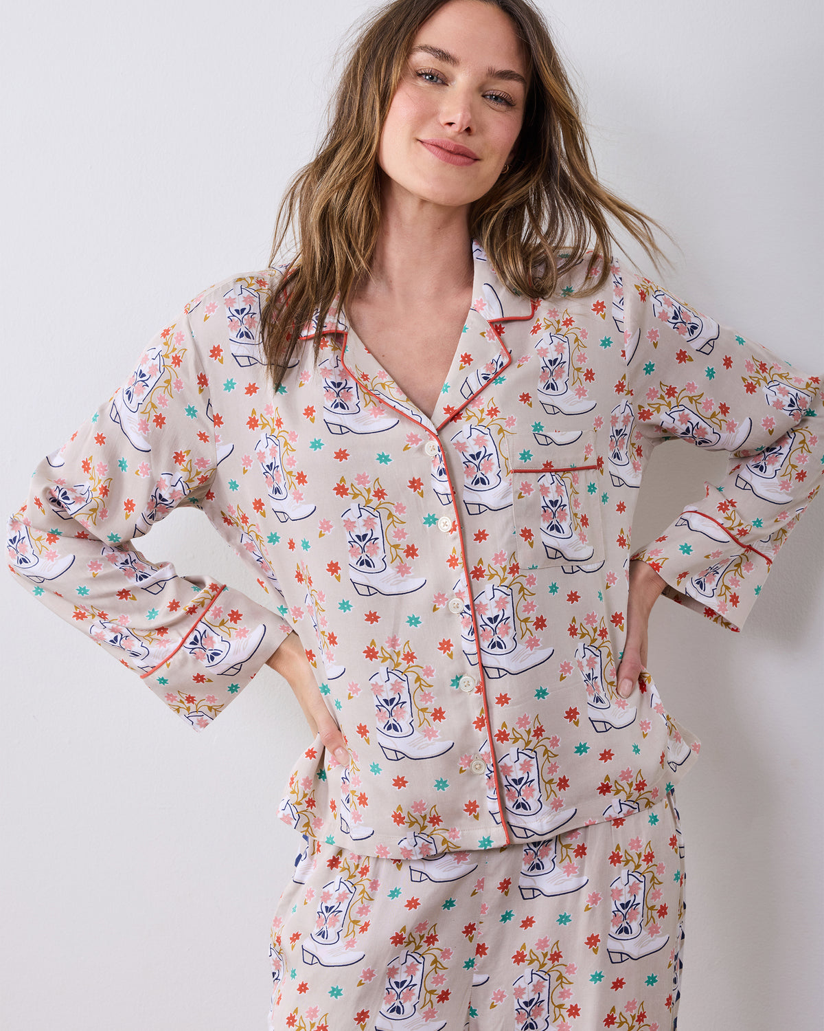 Front close-up of the long-sleeve pajama top with notched collar, buttons, chest pocket, and red piping.