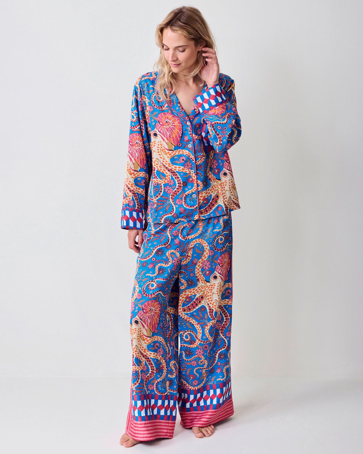 Full-length front view of a model wearing the Octopus Isle pajama set with wide-leg pants and patterned hems